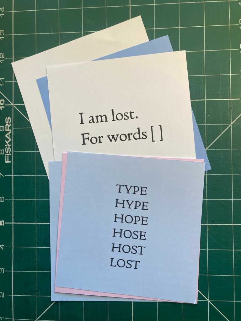 Draft copies of poems spread out on a cutting mat